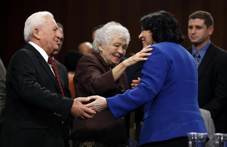 US Supreme Court nominee Judge Sonia Sotomayor (R) is congratulated by her parents, stepfather Omar Lopez and mother Celina Sotomayor, after delivering her prepared testimony at her US Senate Judiciary Committee confirmation hearings on Capitol Hill in Washington, July 13, 2009. [China Daily/Agencies]