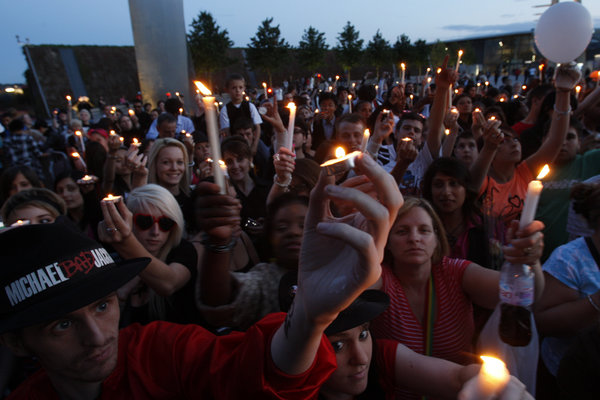 Fans of Michael Jackson hold up their lighted candles as hundreds gathered at O2 arena in London for a tribute celebration, Monday, July 13, 2009. Monday was to have been the opening night of Michael Jackson concerts at the arena but he died on June 25.