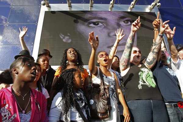 Fans of Michael Jackson sing as hundreds gathered at the O2 arena in London for a tribute celebration, Monday, July 13, 2009. Monday was to have been the opening night of Michael Jackson concerts at the arena but he died on June 25.