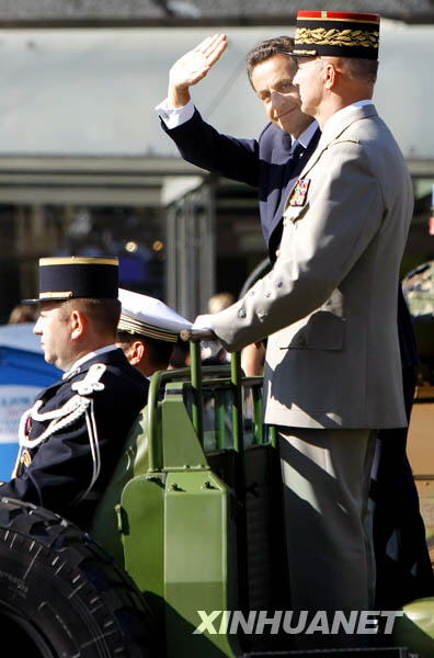 French President Nicolas Sarkozy waves to people during the National Day parade in Paris, France, July 14, 2009. France celebrated its National Day here on Tuesday. [Zhang Yuwei/Xinhua] 