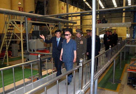 Photo released by Korean Central News Agency on July 14, 2009 shows Kim Jong Il (front R), top leader of the Democratic People's Republic of Korea (DPRK) inspects the newly-built Taedonggang Tile Factory in Pyongyang, the Democratic People's Republic of Korea. [Xinhua/Korean Central News Agency]