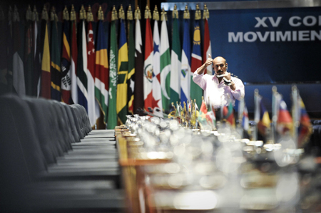 A worker checks translation earphones in the summit hall of Non-Aligned Movement (NAM) in Sharm el-Sheikh, Egypt, on July 14, 2009. The 15th Non-Aligned Movement (NAM) summit will kick off on Wednesday in the Egyptian Red Sea resort city. [Xinhua]