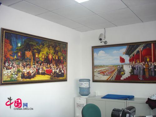 Two oil paintings featuring China's former leaders: 'The Founding Ceremony of China' by Dong Xiwen (L) and 'A Happy Night' by Liu Yuyi. They both hang on the southern wall of the shop.