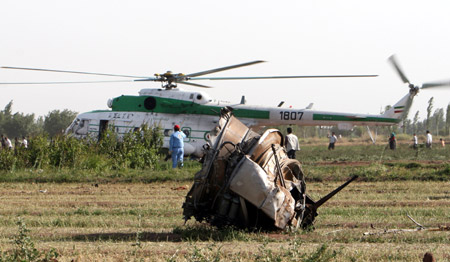 Iranian soldiers gather at the crash site of the Caspian Airlines plane, which fell into farmland near the city of Qazvin, northwest of Tehran on July 15, 2009. [Liang Youchang/Xinhua]