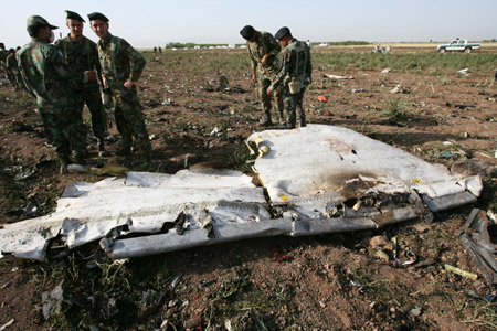 Iranian soldiers gather at the crash site of the Caspian Airlines plane, which fell into farmland near the city of Qazvin, northwest of Tehran on July 15, 2009. [Liang Youchang/Xinhua]