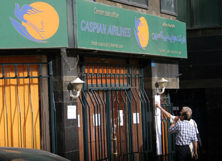 Two men check the roll of the victims in the air crash outside a ticket office of Caspian Airlines in Tehran, capital of Iran, on July 15, 2009. An Iranian Caspian Airlines airliner en route to neighbouring Armenia crashed on Wednesday, killing all 168 people on board in the worst air disaster in Iran in recent years. [Ahmad Halabisaz/Xinhua]