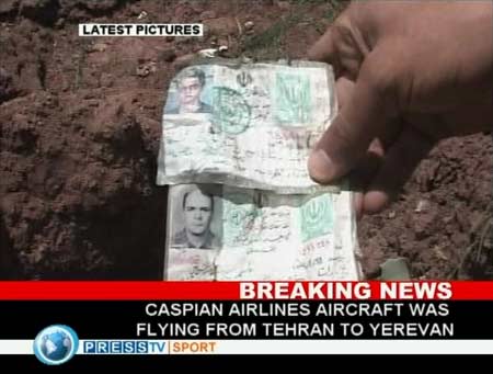 Image taken from television footage shows Iranian identity cards at the site where a Tupolev passenger aircraft crashed near the village of Jannat-abad in Qazvin July 15, 2009. [Xinhua/Reuters]