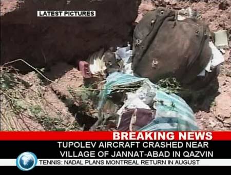 Image taken from television footage shows debris at the site where a Tupolev passenger aircraft crashed near the village of Jannat-abad in Qazvin July 15, 2009. [Xinhua/Reuters]