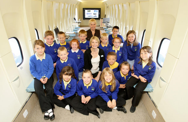 Year 3 and year 4 pupils and teacher Anne Grattage (centre) from Kingsland Primary School in Stoke on Trent, inside the plane they use as a classroom. [CFP]