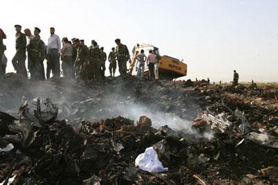 Iranian soldiers gather at the crash site of the Caspian Airlines plane, which fell into farmland near the city of Qazvin, northwest of Tehran on July 15, 2009. [Liang Youchang/Xinhua] 