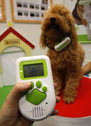 Japanese toymaker TOMY Company's 'Bowlingual voice' device, which the company says 'translates' dog emotions, is displayed at the International Tokyo Toy Show, July 16, 2009. The wireless microphone device, which fits on a dog's collar, transmits the animal's sound to a handheld consul which analyses and 'translates' into six emotional categories. The device then emits a common phrase matching the dog's emotional state, both in words and voices. [Xinhua/Reuters]