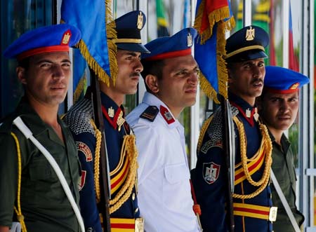 Soldiers stand guard at the gate of the venue of the 15th Non-Aligned Movement (NAM) Summit in Sharm el-Sheikh, a Red Sea resort city in Egypt, July 16, 2009. The 15th NAM summit closed here Thursday, with the approval of a final document and a declaration calling for solidarity among member states to address global threats and challenges and promote world peace and development. [Xinhua]