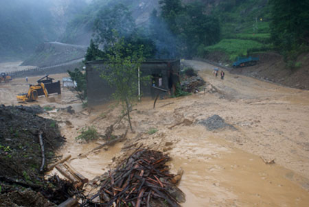 The path for pedestrian at the Donghekou Earthquake Relics Park is flooded in Qingchuan County, southwest China's Sichuan Province, July 15, 2009. Heavy rains that began on Tuesday have killed one people and caused the ohter missing in Qingchuan County. [Xinhua]