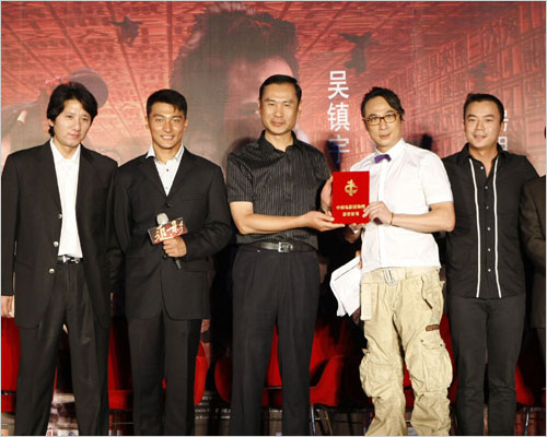 Hong Kong actor and director Francis Ng (4th from left) donated the first copy of his latest kung-fu comedy 'Tracing Shadow' on Thursday to China National Film Museum in Beijing.