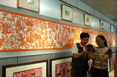 Paper cuts are on display during an exhibition in Ansai County, Yan'an City of northwest China's Shaanxi Province, on July 17, 2009. Ansai County is famous for its paper-cutting handicrafts, which is one of the most popular folk arts in China. [Xinhua]