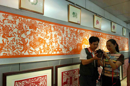Paper cuts are on display during an exhibition in Ansai County, Yan'an City of northwest China's Shaanxi Province, on July 17, 2009. Ansai County is famous for its paper-cutting handicrafts, which is one of the most popular folk arts in China. (Xinhua/Zhao Yusi)