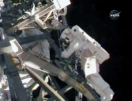 Astronaut Tim Kopra works during his spacewalk outside the International Space Station in in this image from NASA TV July 18, 2009.