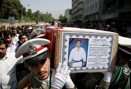 People attend the funeral of eight judo athletes and their two coaches dead in a recent air crash, in Tehran, July 19, 2009. An Iranian airliner en route to neighbouring Armenia crashed on July 15, killing all 168 people on board in the worst air disaster in Iran in recent years. (Xinhua/Ahmad Halabisaz)