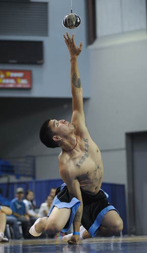 A competitor reaches for the ball during the One Hand Reach contest in the 2009 World Eskimo-Indian Olympics held in Fairbanks, Alaska of the United States, July 18, 2009. This contest originated from the Eskimo's celebration after whaling.