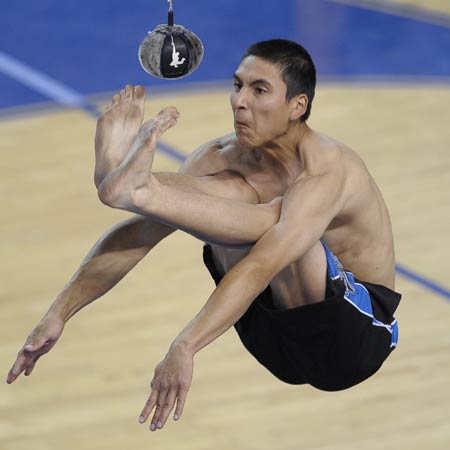 A competitor kicks the ball with his feet during the Two-Feet High Kick contest in the 2009 World Eskimo-Indian Olympics held in Fairbanks, Alaska of the United States, July 18, 2009. This contest originated from the Eskimo's celebration after whaling. A good competitor can reach as high as 2.5m.