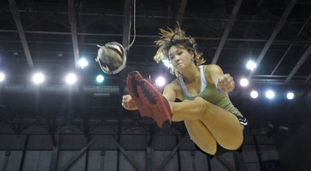 A competitor kicks the ball with his feet during the Two-Feet High Kick contest in the 2009 World Eskimo-Indian Olympics held in Fairbanks, Alaska of the United States, July 18, 2009. This contest originated from the Eskimo's celebration after whaling. A good competitor can reach as high as 2.5m.