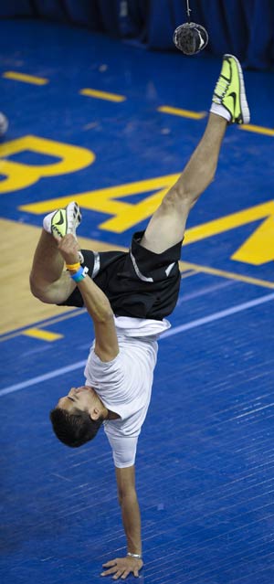 A competitor standing on one hand kicks the ball with one foot during the Alaskan High Kick contest in the 2009 World Eskimo-Indian Olympics held in Fairbanks, Alaska of the United States, July 18, 2009. This contest originated from the Eskimo's celebration after whaling. A good competitor can reach above 2.15m.