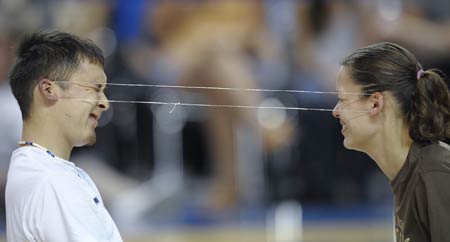 A young man and a young woman compete in the Ear Pull contest in the 2009 World Eskimo-Indian Olympics held in Fairbanks, Alaska of the United States, July 18, 2009.