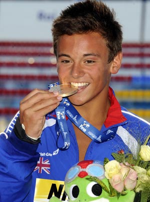 Gold medallist Thomas Daley of Britain bites his medal on the podium after winning the men's 10m platform diving final at the World Championships in Rome.
