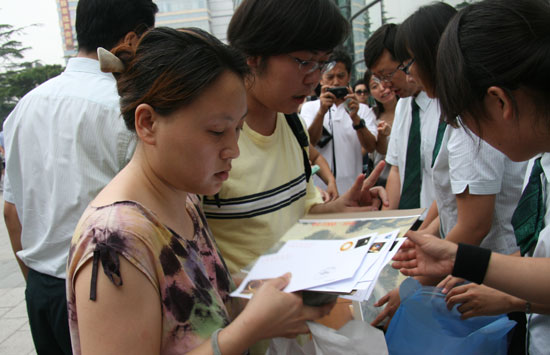 A woman buys limited edition eclipse memorial stamps at Beijing Planetarium on the morning of July 22 2009. Some areas in south China witnessed a full solar eclipse on that day. But people in Beijing only saw a partial eclipse.