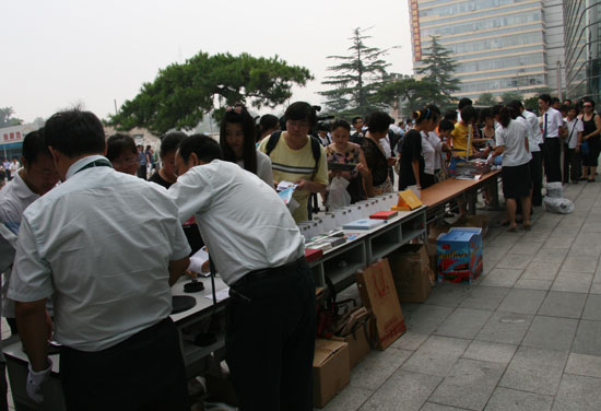 People queue to buy limited edition eclipse memorial stamps at Beijing Planetarium on the morning of July 22 2009. Some areas in south China witnessed a full solar eclipse on that day. But people in Beijing only saw a partial eclipse. 