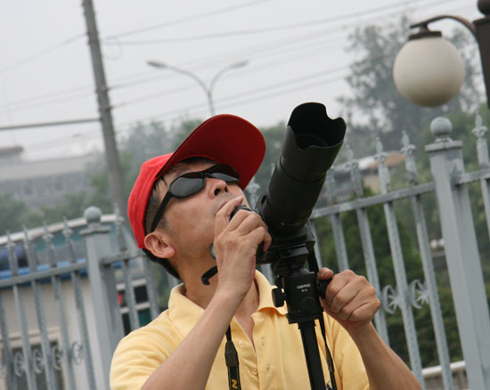 An astronomy enthusiast prepares to take pictures of the solar eclipse at Beijing Planetarium on the morning of July 22 2009. Some areas in south China witnessed a full solar eclipse on that day. But people in Beijing only saw a partial eclipse. 