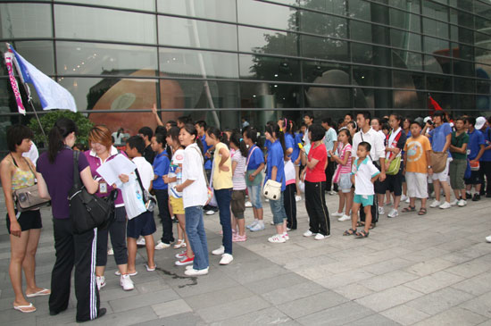 A group of students from Yunnan province wait to enter Beijing Planetarium to watch a live broadcast of solar eclipse on the morning July 22 2009. Some areas in south China witnessed a full solar eclipse on that day. But people in Beijing only saw a partial eclipse. 