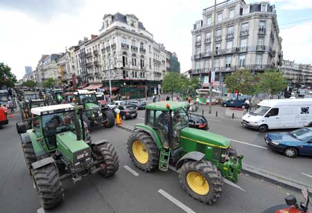 Farmers drive tractors passing main streets during a protest in Brussels, capital of Belgium, on July 22, 2009. More than 300 tractors gathered in Brussels during a famers' protest seeking for higher agricultural prices Wednesday. 