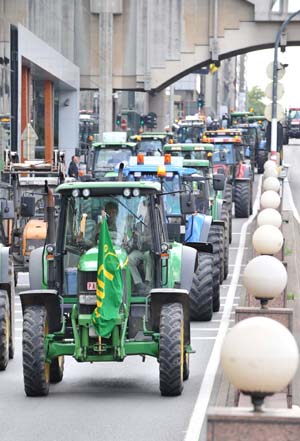 Farmers drive tractors passing main streets during a protest in Brussels, capital of Belgium, on July 22, 2009. More than 300 tractors gathered in Brussels during a famers' protest seeking for higher agricultural prices Wednesday. 