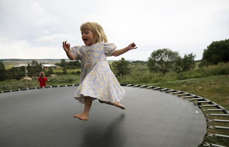 Havilah Jeub, 3, plays on the family trampoline outside their home in Monument, Colorado July 19, 2009. 