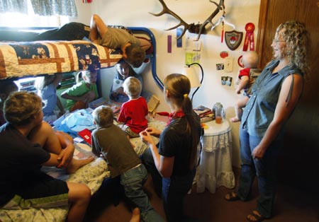 Cynthia Jeub (in bed, R) opens a birthday card from her siblings in a family tradition of breakfast in bed on her 17th birthday with her mother Wendy (R) looking on at the family home in Monument, Colorado July 17, 2009. 