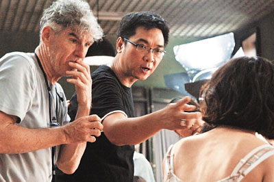 This undated photo shows Stanley Kwan (M) and Christopher Doyle (L) on the set of 'Energy behind the Heart.'