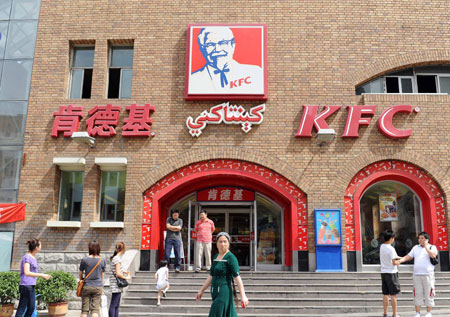 People are seen in front of the KFC store in the international bazar in Urumqi, capital of northwest China's Xinjiang Uygur Autonomous Region, July 23, 2009. The KFC store in the international bazar, which was closed after the July 5 riot, was reopened on Thursday. (Xinhua/Sadat)