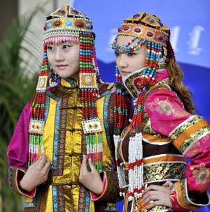 Models display traditional garments of the Qahar Mongolian ethnic group, during the grassland cultural festival in Hohhot, capital of north China's Inner Mongolia Autonomous Region, July 14, 2009.