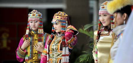 Models display traditional garments of the Qahar Mongolian ethnic group, during the grassland cultural festival in Hohhot, capital of north China's Inner Mongolia Autonomous Region, July 14, 2009.