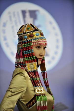 A model displays a traditional garment of the Qahar Mongolian ethnic group, during the grassland cultural festival in Hohhot, capital of north China's Inner Mongolia Autonomous Region, July 14, 2009.