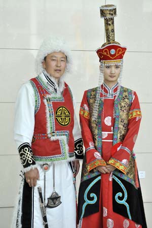 Models display traditional garments of the Qahar Mongolian ethnic group, during the grassland cultural festival in Hohhot, capital of north China's Inner Mongolia Autonomous Region, July 14, 2009.