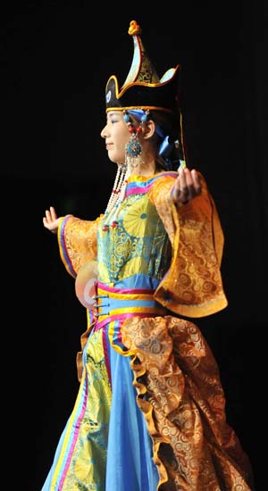 A model displays a traditional garment of the Sonid Mongolian ethnic group, during the grassland cultural festival in Hohhot, capital of north China's Inner Mongolia Autonomous Region, July 15, 2009.