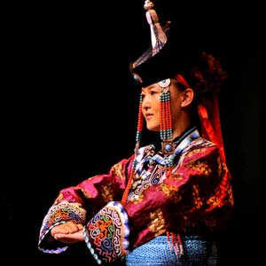  A model displays a traditional garment of the Sonid Mongolian ethnic group, during the grassland cultural festival in Hohhot, capital of north China's Inner Mongolia Autonomous Region, July 15, 2009.