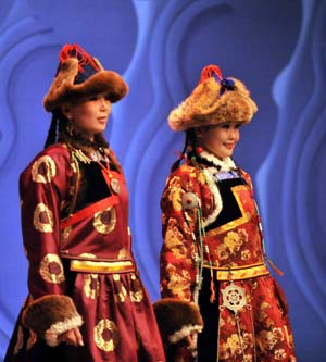 Models display traditional garments of the Buriat Mongolian ethnic group in Hohhot, capital of north China's Inner Mongolia Autonomous Region, July 14, 2009.