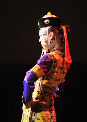 A model displays a traditional garment of the Sonid Mongolian ethnic group, during the grassland cultural festival in Hohhot, capital of north China's Inner Mongolia Autonomous Region, July 15, 2009.