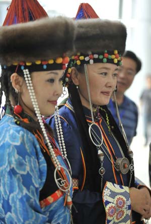 Models display traditional garments of the Buriat Mongolian ethnic group, in Hohhot, capital of north China's Inner Mongolia Autonomous Region, July 14, 2009.