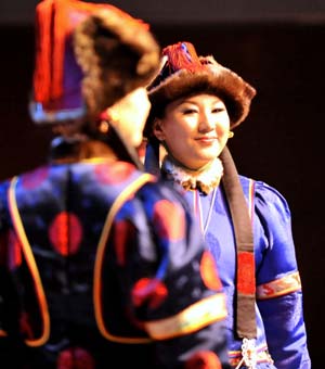  Models display traditional garments of the Buriat Mongolian ethnic group, in Hohhot, capital of north China's Inner Mongolia Autonomous Region, July 14, 2009.