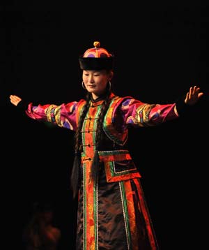  A model displays a traditional garment of the Sonid Mongolian ethnic group, during the grassland cultural festival in Hohhot, capital of north China's Inner Mongolia Autonomous Region, July 15, 2009.