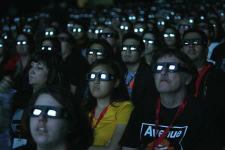 Visitors wear 3D glasses as they watch a preview of the upcoming movie "Avatar" during the 40th annual Comic Con Convention in San Diego July 23, 2009. The convention runs from July 23 to July 26. 